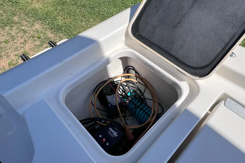 Slide: The Image of Open storage compartment on 2020 Key West 230 Bay Reef boat, showing cables and equipment. - 30