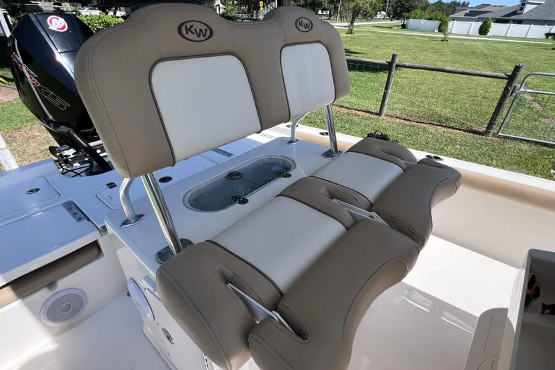 Slide: The Image of 2020 Key West 230 Bay Reef boat interior with cushioned seating and motor. - 33