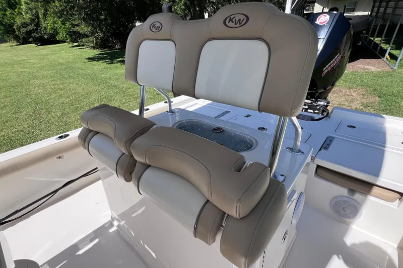 Slide: The Image of 2020 Key West 230 Bay Reef boat interior with cushioned seating and motor. - 34