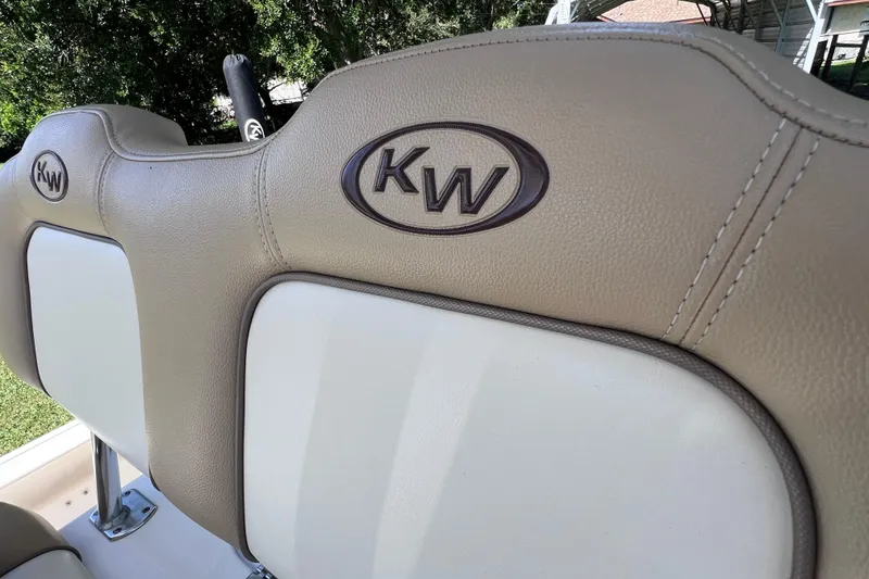 Slide: The Image of Key West 230 Bay Reef 2020 boat seat with KW logo, beige and white upholstery. - 35