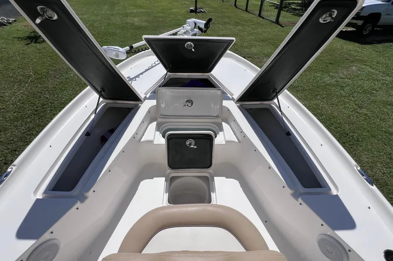 Slide: The Image of 2020 Key West 230 Bay Reef boat with open storage compartments on grassy area. - 37