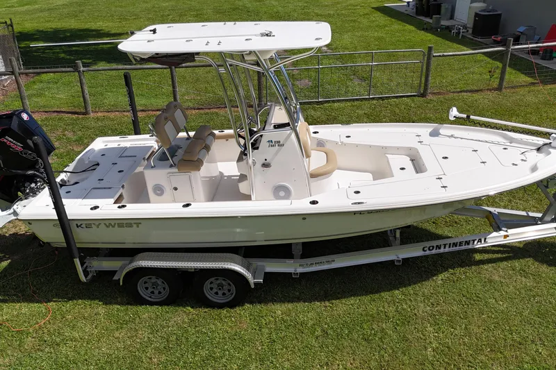 Slide: The Image of 2020 Key West 230 Bay Reef boat on trailer, parked on grass. - 4