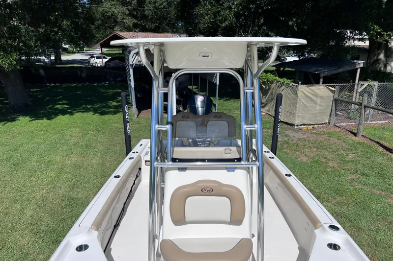 Slide: The Image of 2020 Key West 230 Bay Reef boat with T-top and seating, parked on grass. - 43