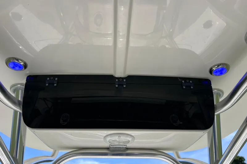 Slide: The Image of 2020 Key West 230 Bay Reef boat T-top with blue LED lights and storage compartment. - 47