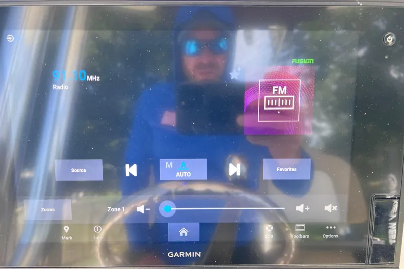 Slide: The Image of Touchscreen display on 2020 Key West 230 Bay Reef showing FM radio interface. - 53