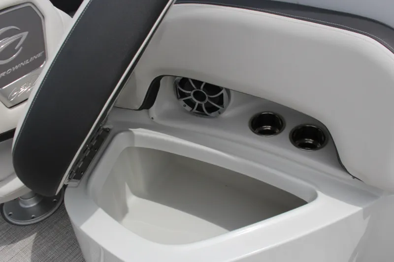 Slide: The Image of 2023 Crownline E235 boat interior with storage compartment and cup holders. - 1