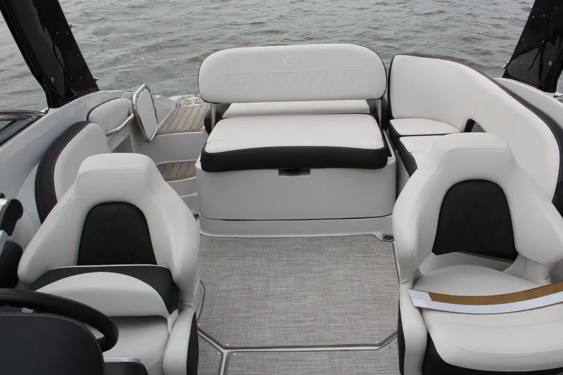 Slide: The Image of 2023 Crownline E235 boat interior with luxurious seating and modern design on the water. - 14