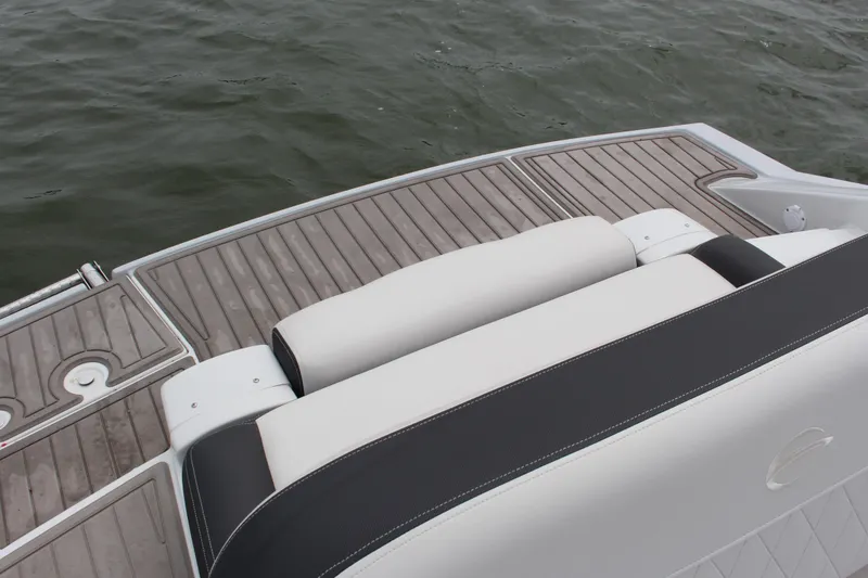 Slide: The Image of 2023 Crownline E235 boat with sleek seating and elegant deck design on water. - 21