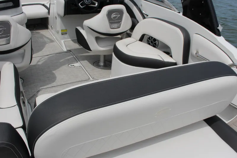 Slide: The Image of 2023 Crownline E235 boat interior with luxurious white and black seating. - 28