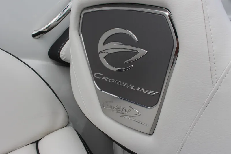 Slide: The Image of 2023 Crownline E235 Gen 2 logo on white leather boat interior. - 4