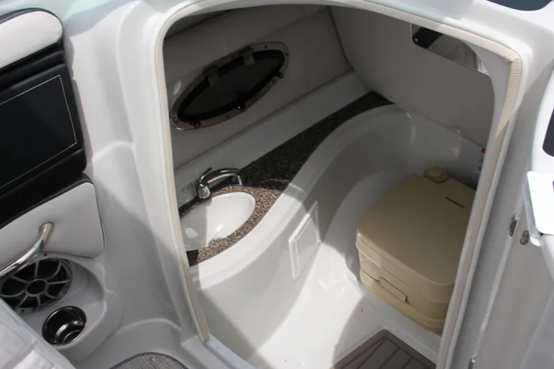 Slide: The Image of 2023 Crownline E235 boat interior with sink and portable toilet. - 6