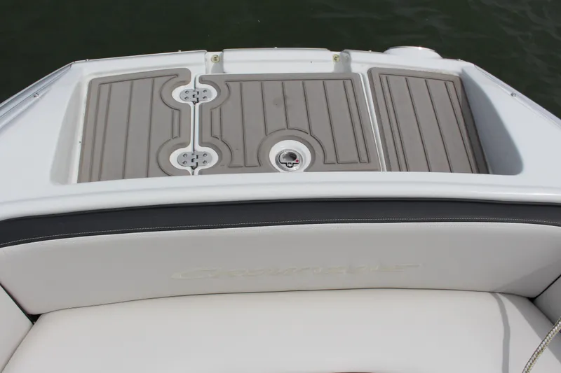 Slide: The Image of 2023 Crownline E235 boat deck with cushioned seating and non-slip surface. - 8