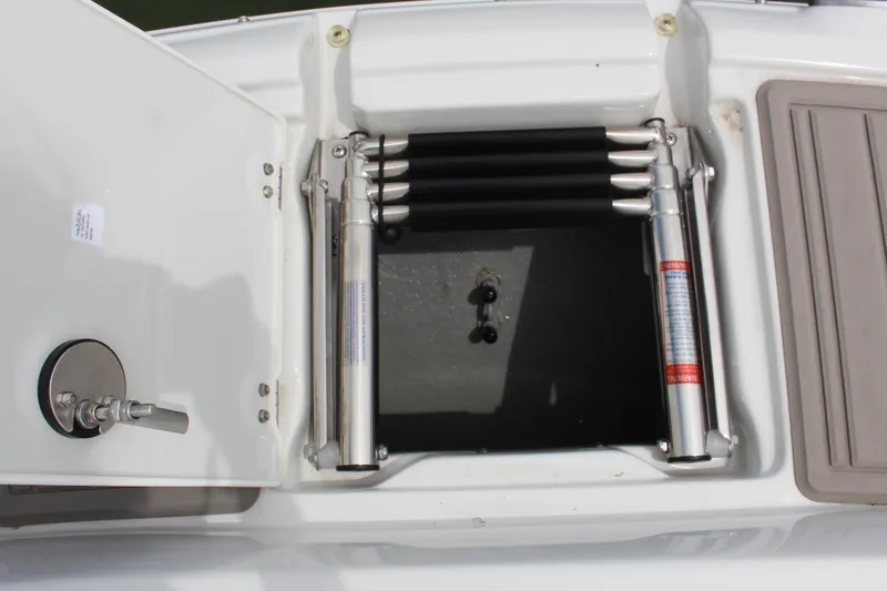 Slide: The Image of 2023 Crownline E235 boat storage compartment with hydraulic lift and stainless steel fittings. - 9