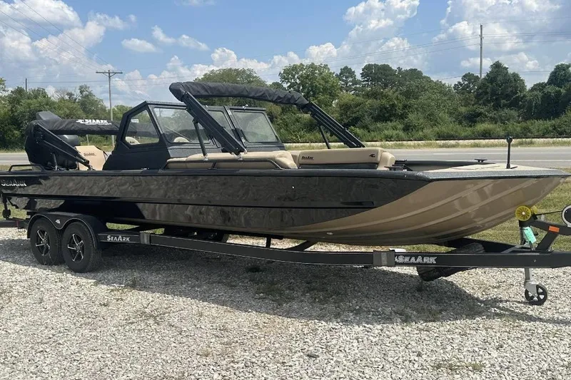 The Image of 2026 SeaArk EasyCat boat on trailer, parked outdoors under a cloudy sky. - 0
