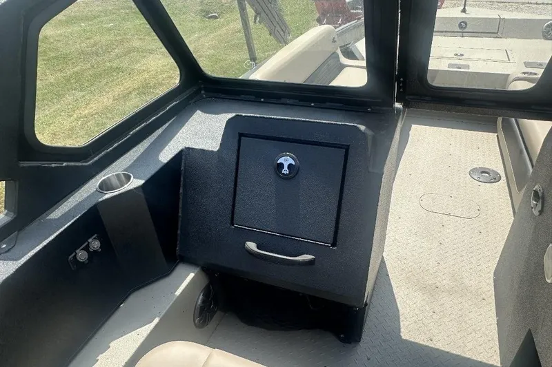 Slide: The Image of 2026 SeaArk EasyCat interior with storage compartment and cup holder. - 11