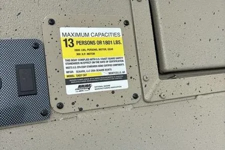 Slide: The Image of 2026 SeaArk EasyCat capacity label, maximum 13 persons or 1801 lbs, compliance details. - 12