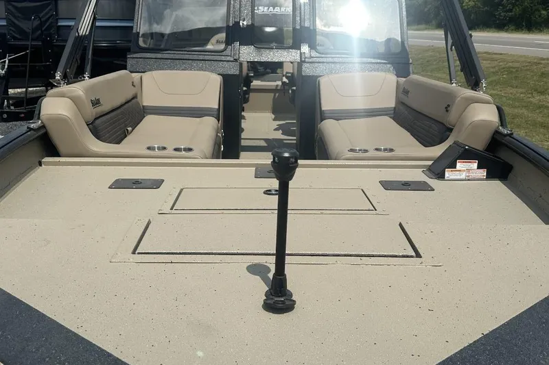 Slide: The Image of 2026 SeaArk EasyCat boat interior with beige seating and cup holders. - 3