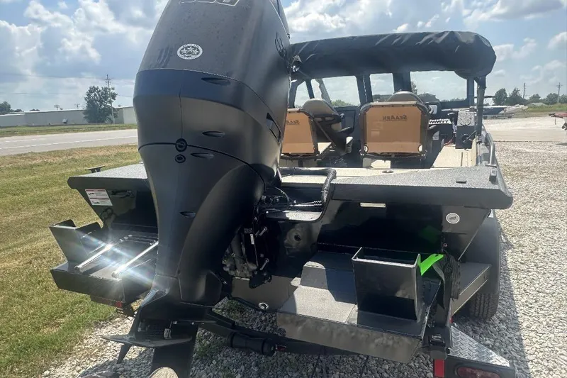Slide: The Image of 2026 SeaArk EasyCat boat with powerful outboard motor, parked on gravel under a sunny sky. - 4