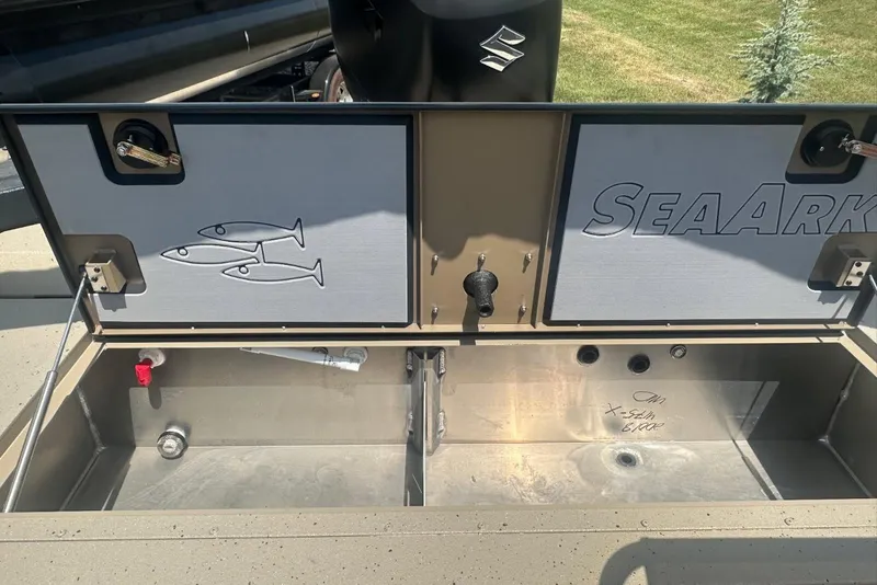 Slide: The Image of 2026 SeaArk EasyCat boat storage compartment with fish graphics and Suzuki motor. - 7
