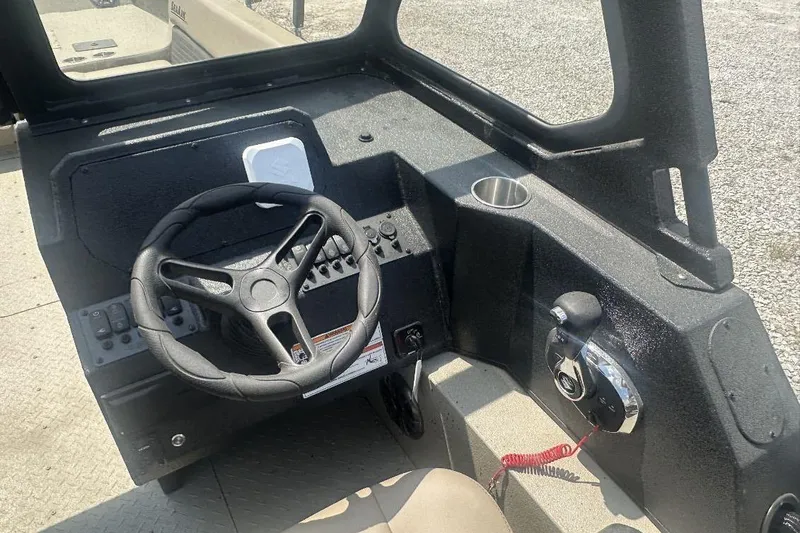 Slide: The Image of 2026 SeaArk EasyCat boat dashboard with steering wheel and control panel. - 9