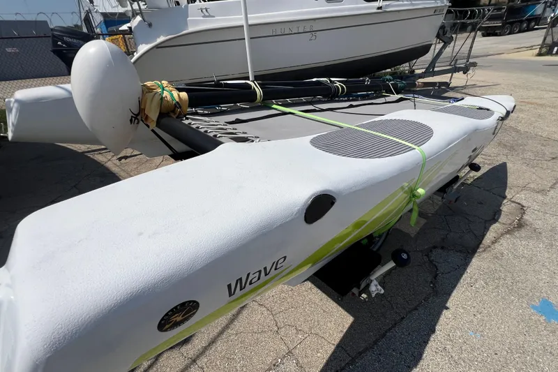 Slide: The Image of 2019 Hobie Cat Wave 13 sailboat on trailer, docked outdoors. - 5