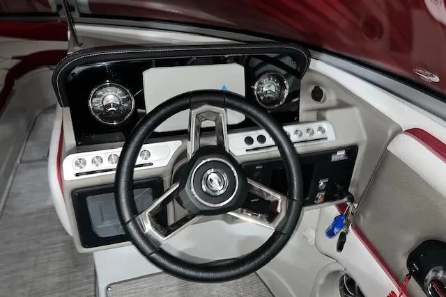 Slide: The Image of 2023 Crownline E255 boat dashboard with steering wheel and control panel. - 4