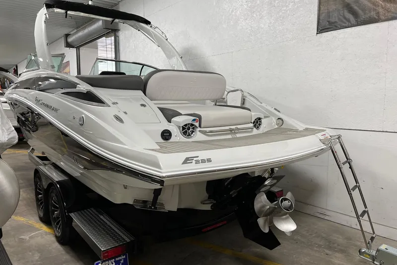 Slide: The Image of 2023 Crownline E285 boat in showroom, featuring sleek design and modern amenities. - 10