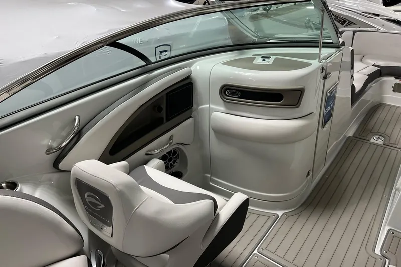 Slide: The Image of 2023 Crownline E285 boat interior with sleek seating and modern dashboard design. - 5
