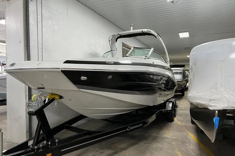 Slide: The Image of 2023 Crownline E285 boat on trailer in indoor storage facility. - 9