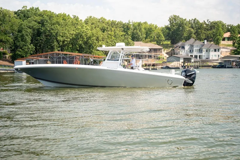 Slide: The Image of 2018 Fountain 38 SCX boat on a lake with waterfront homes in the background. - 1