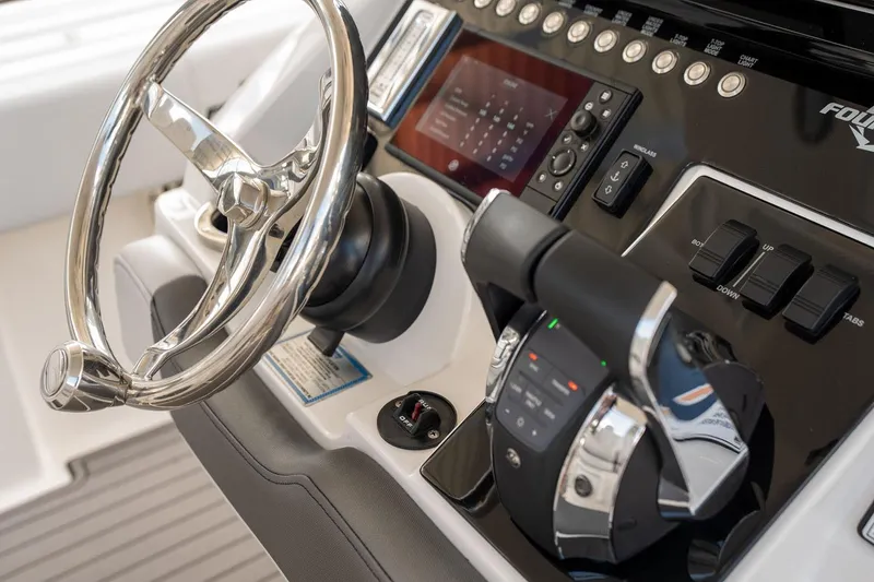 Slide: The Image of Steering console of 2018 Fountain 38 SCX boat with modern controls and display. - 13