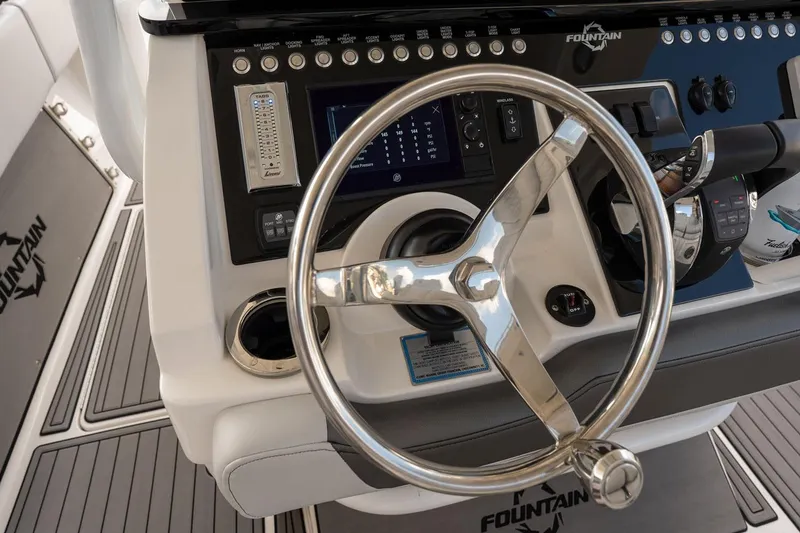 Slide: The Image of Steering wheel and controls of a 2018 Fountain 38 SCX boat cockpit. - 14