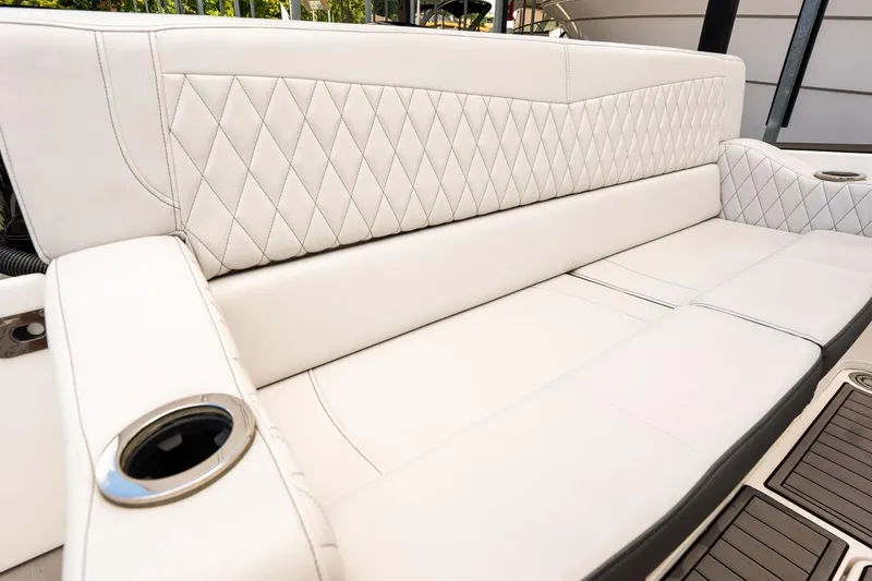 Slide: The Image of Luxurious white seating on 2018 Fountain 38 SCX boat with diamond stitching and cup holders. - 19