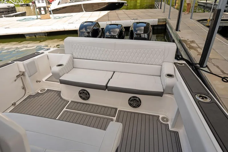 Slide: The Image of Luxurious seating area on a 2018 Fountain 38 SCX boat docked at a marina. - 21