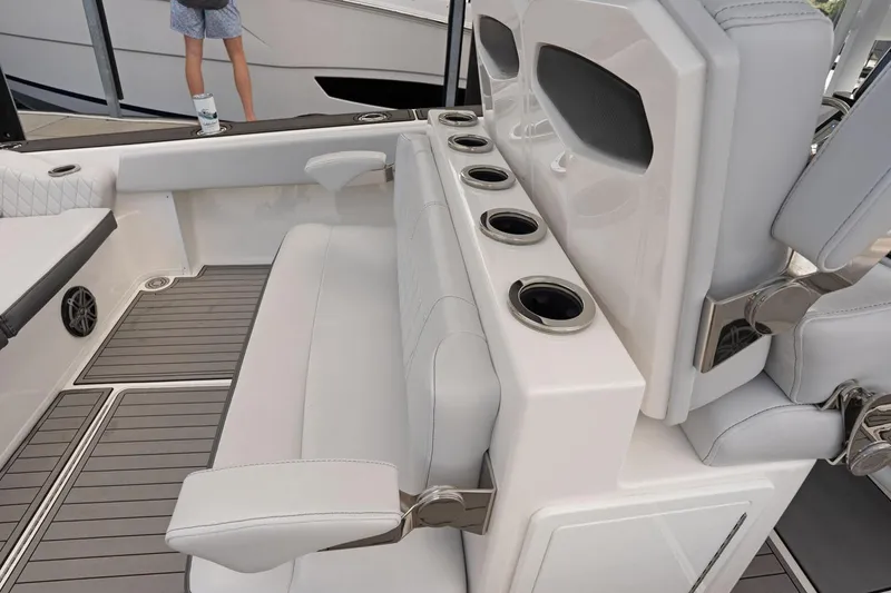 Slide: The Image of 2018 Fountain 38 SCX boat interior with cushioned seating and cup holders. - 23
