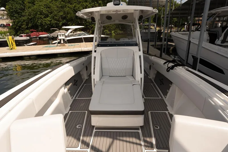 Slide: The Image of 2018 Fountain 38 SCX boat interior with sleek seating and modern design at a marina. - 24