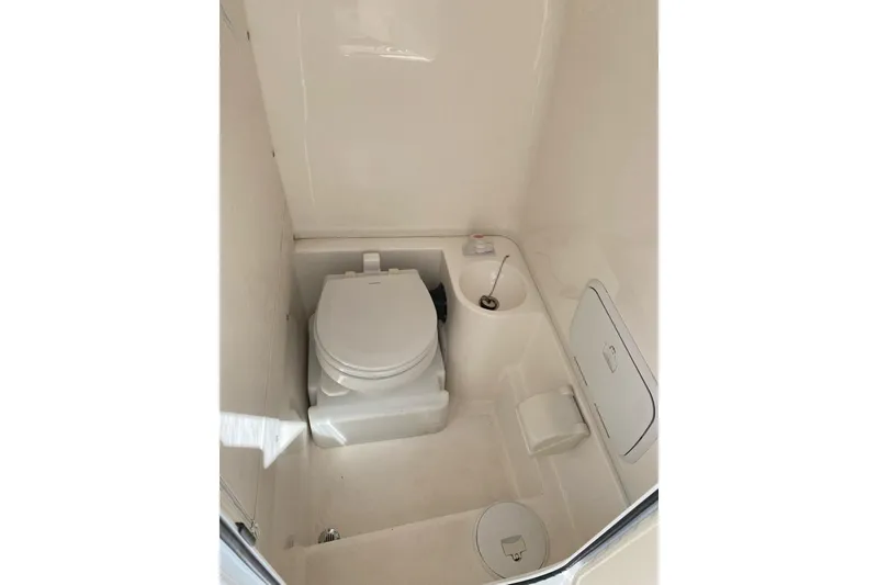 Slide: The Image of 2018 Fountain 38 SCX boat bathroom with toilet and storage compartments. - 28