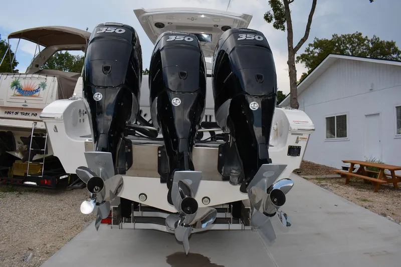 Slide: The Image of 2018 Fountain 38 SCX boat with triple 350 horsepower engines, docked outdoors. - 32