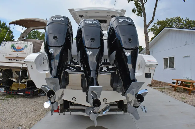 Slide: The Image of 2018 Fountain 38 SCX boat with triple 350 horsepower engines, docked outdoors. - 33