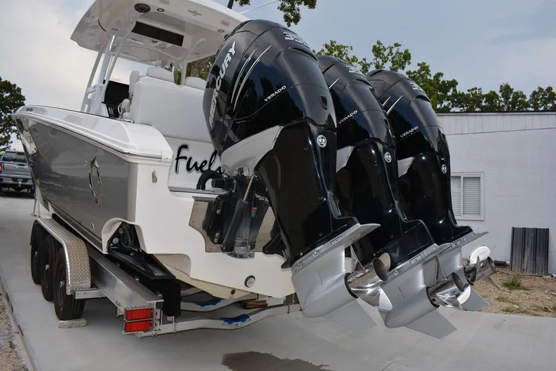 Slide: The Image of 2018 Fountain 38 SCX boat with triple Mercury outboard engines on a trailer. - 34