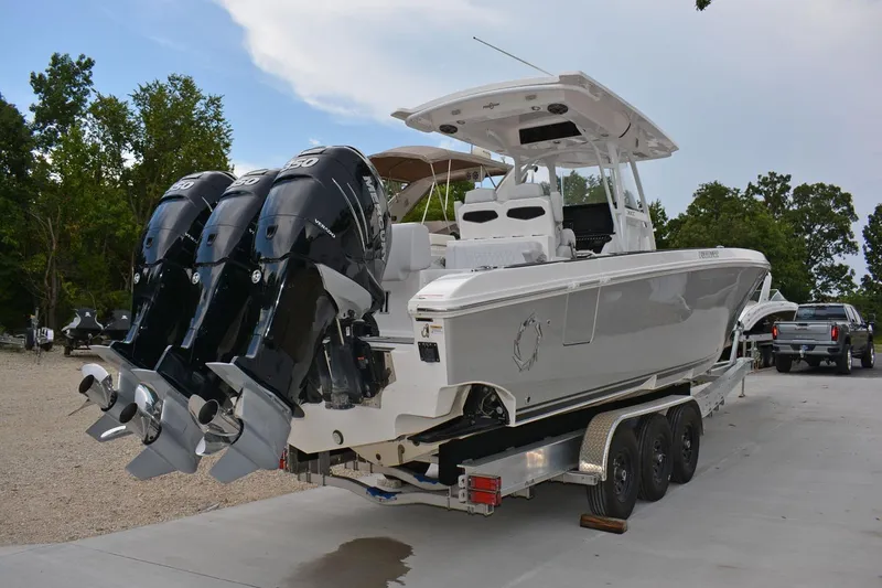 Slide: The Image of 2018 Fountain 38 SCX boat with triple Mercury outboard engines on a trailer. - 35