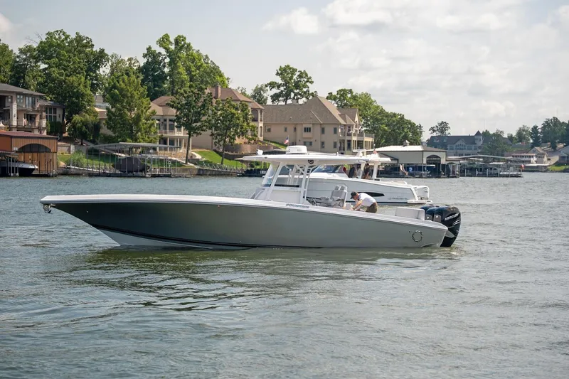 Slide: The Image of 2018 Fountain 38 SCX boat on a lake near waterfront homes. - 4