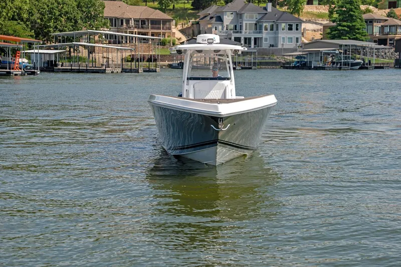 Slide: The Image of 2018 Fountain 38 SCX boat on a lake with waterfront homes in the background. - 8