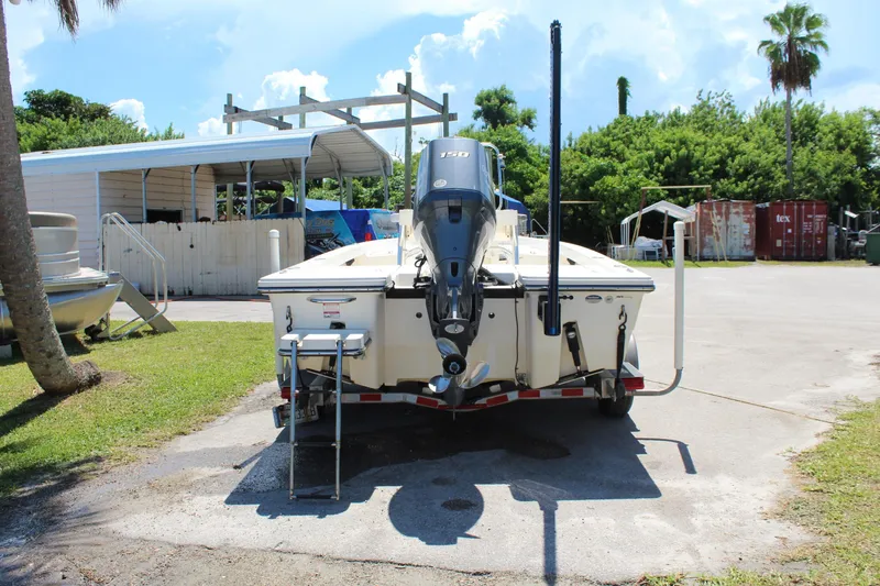 Slide: The Image of 2015 Pathfinder 2200 boat on trailer, parked outdoors near a storage facility. - 10