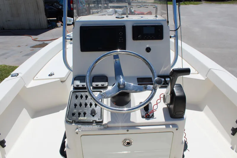 Slide: The Image of 2015 Pathfinder 2200 boat console with steering wheel and control panel. - 12