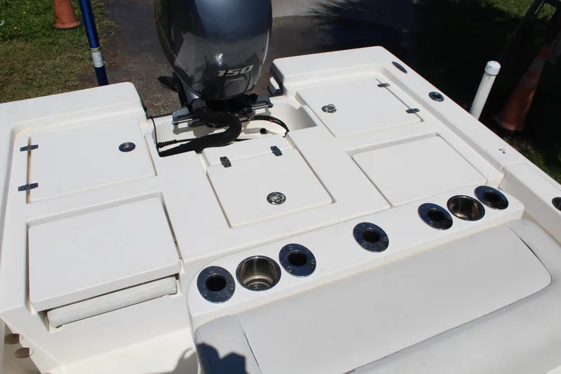 Slide: The Image of 2015 Pathfinder 2200 boat deck with Yamaha 150 engine, featuring storage compartments and cup holders. - 13