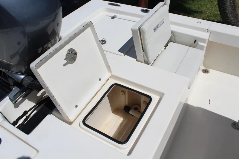 Slide: The Image of 2015 Pathfinder 2200 boat with open storage compartments and visible engine. - 16