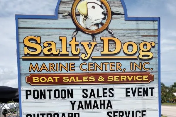 Slide: The Image of Salty Dog Marine Center sign advertising pontoon sales, Yamaha outboard service, boat sales, and service. - 25