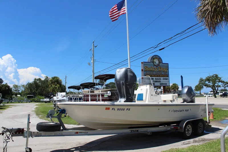 Slide: The Image of 2015 Pathfinder 2200 boat on trailer at Salty Dog Marine Center, under clear blue sky. - 4