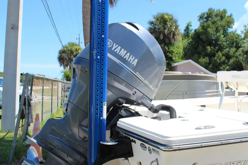 Slide: The Image of 2015 Pathfinder 2200 boat with Yamaha outboard motor, parked outdoors. - 9